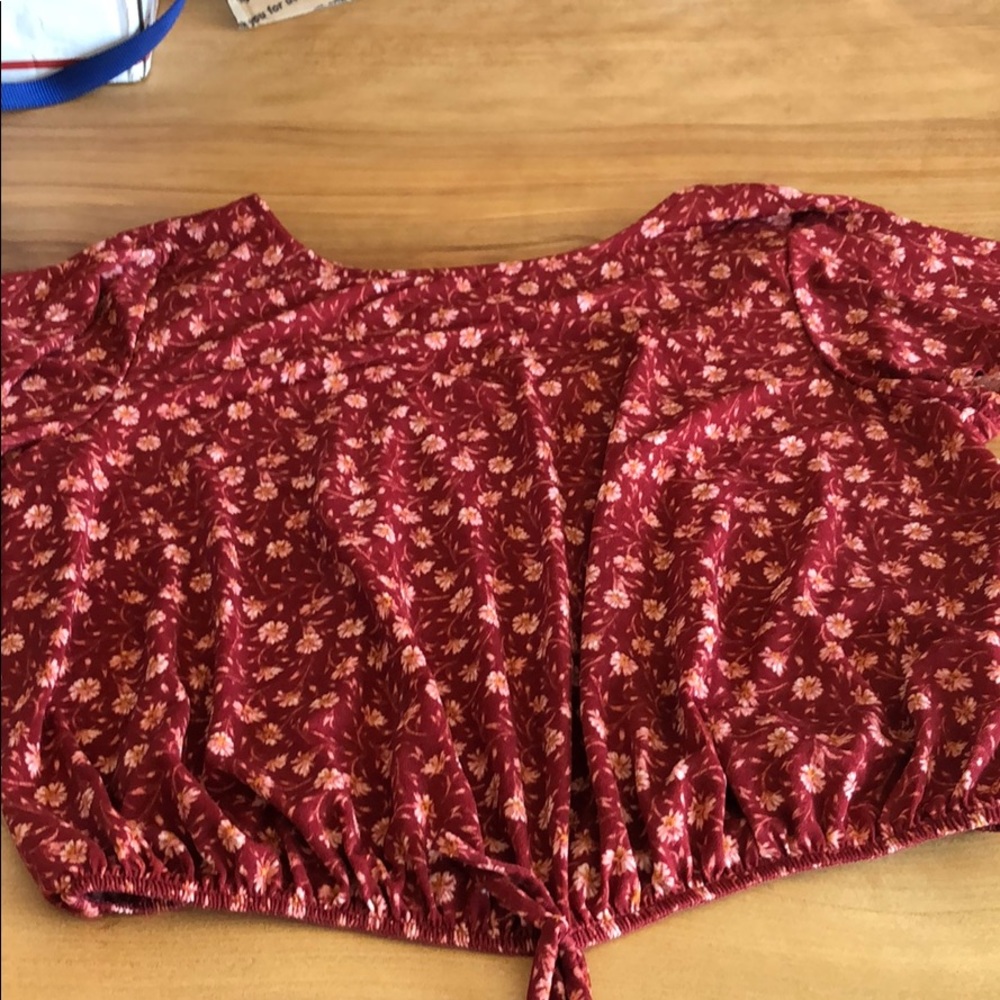 Red blouse with pink flowers and a strappy back